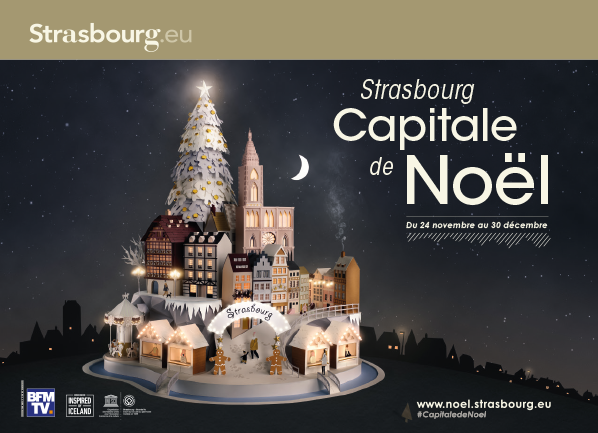 Affiche mettant en scène une œuvre de papier représentant la ville de Strasbourg, capitale de Noël